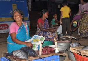 Women selling fish with candles